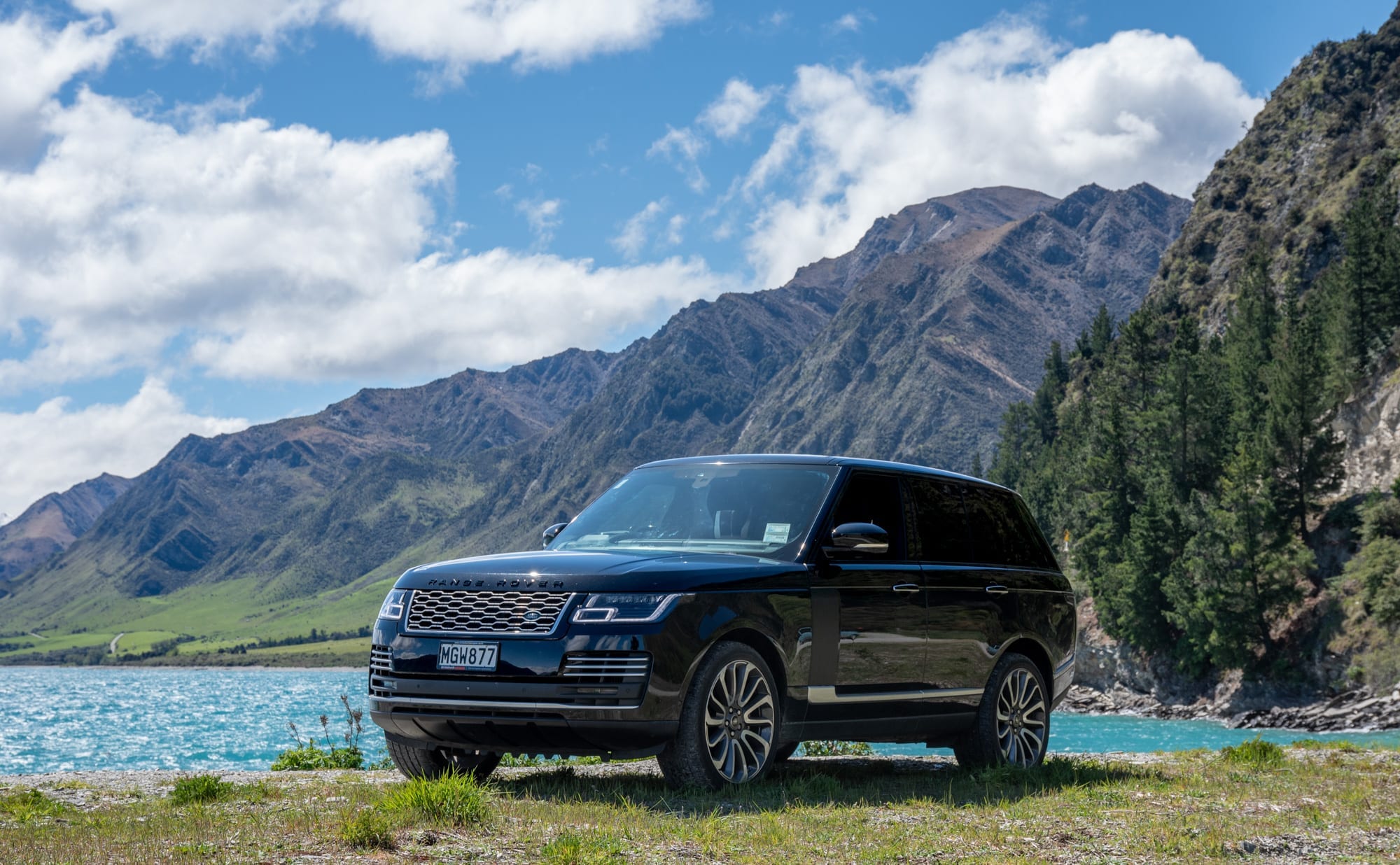 Range Rover Vogue on the shore of Lake Hāwea beneath the Southern Alps.